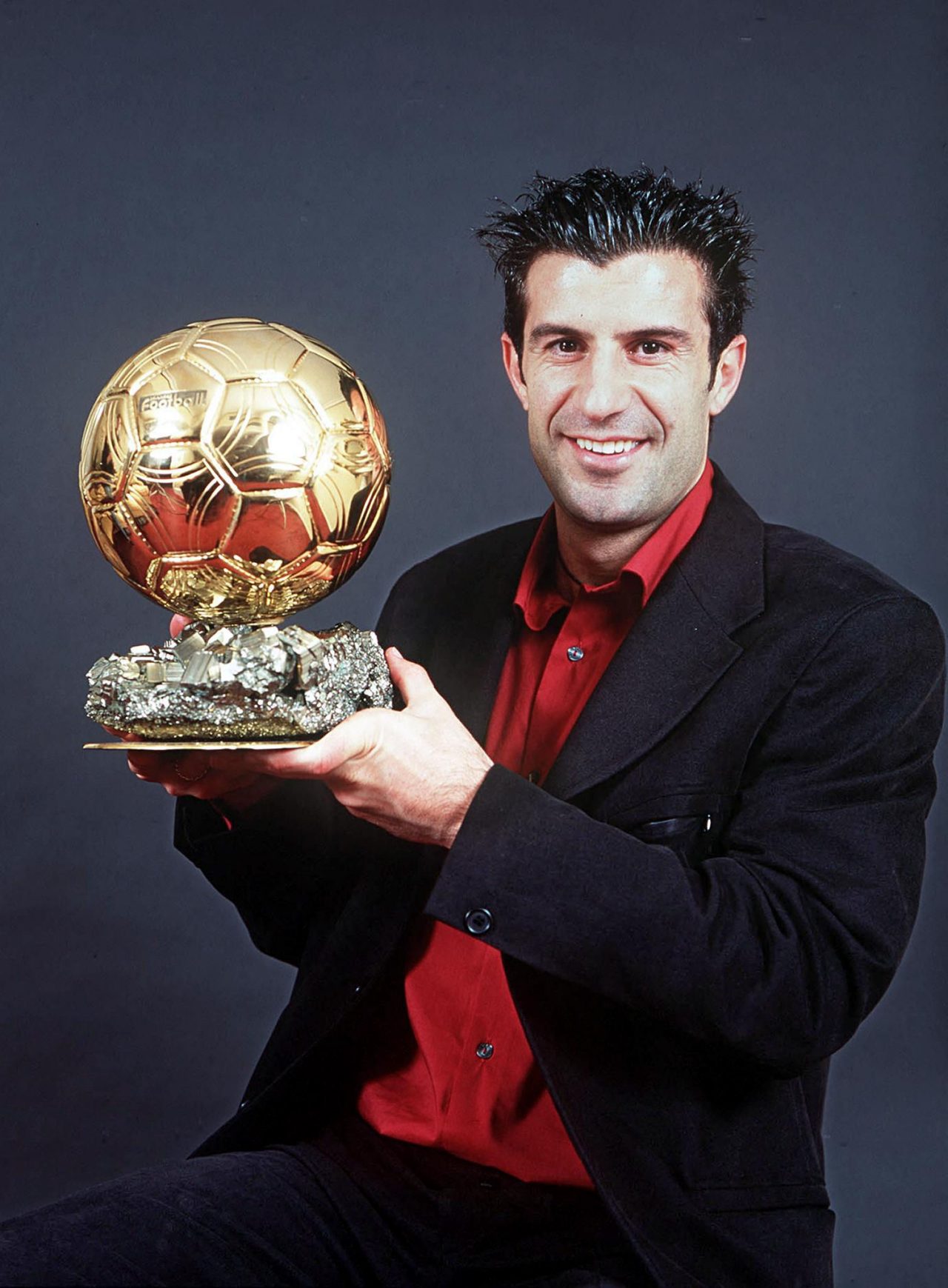 A picture released 13 December 2000 shows Portugal and Real Madrid star Luis Figo, the most expensive player in the world, posing with his  prestigious 2000 Ballon d'Or awarded by France Football magazine. AFP PHOTO ALAIN MARTIGNAC (Photo by ALAIN DE MARTIGNAC / FRANCE FOOTBALL / AFP) (Photo by ALAIN DE MARTIGNAC/FRANCE FOOTBALL/AFP via Getty Images)